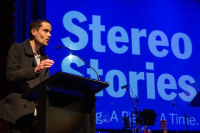 Writer speaking at a microphone